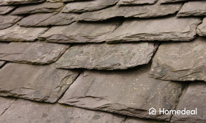 Close-up van een leien dak met overlappende natuurleien. De karakteristieke dakbedekking biedt een duurzame, weerbestendige en stijlvolle afwerking voor woningen en monumentale panden.